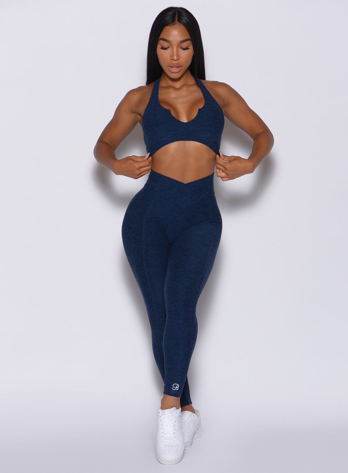 Front profile picture of a model in our Brazilian Contour Leggings in sapphire blue color and a matching bra