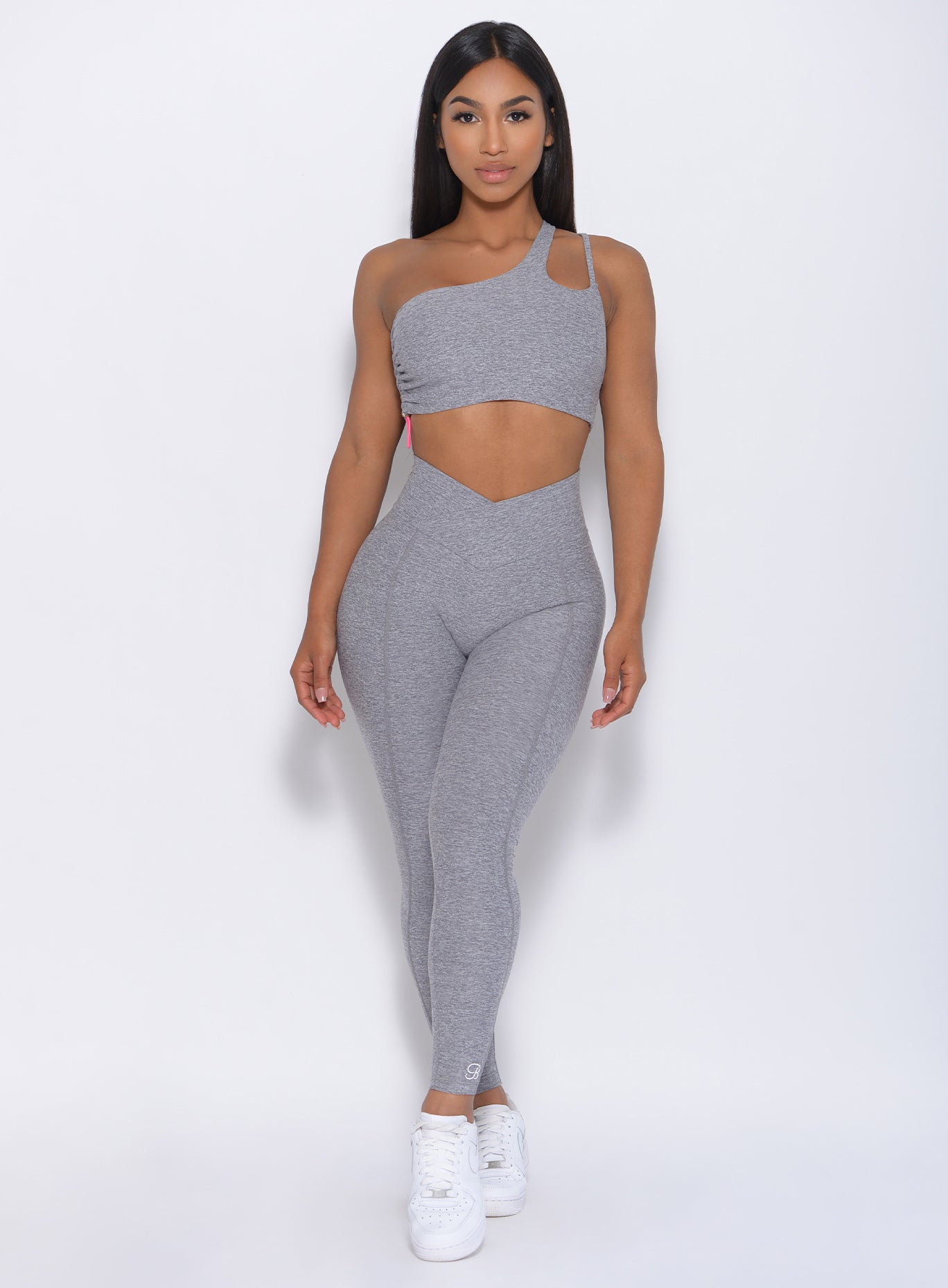 Front profile view of the model in our Brazilian Contour Legging in cloud color and a matching bra