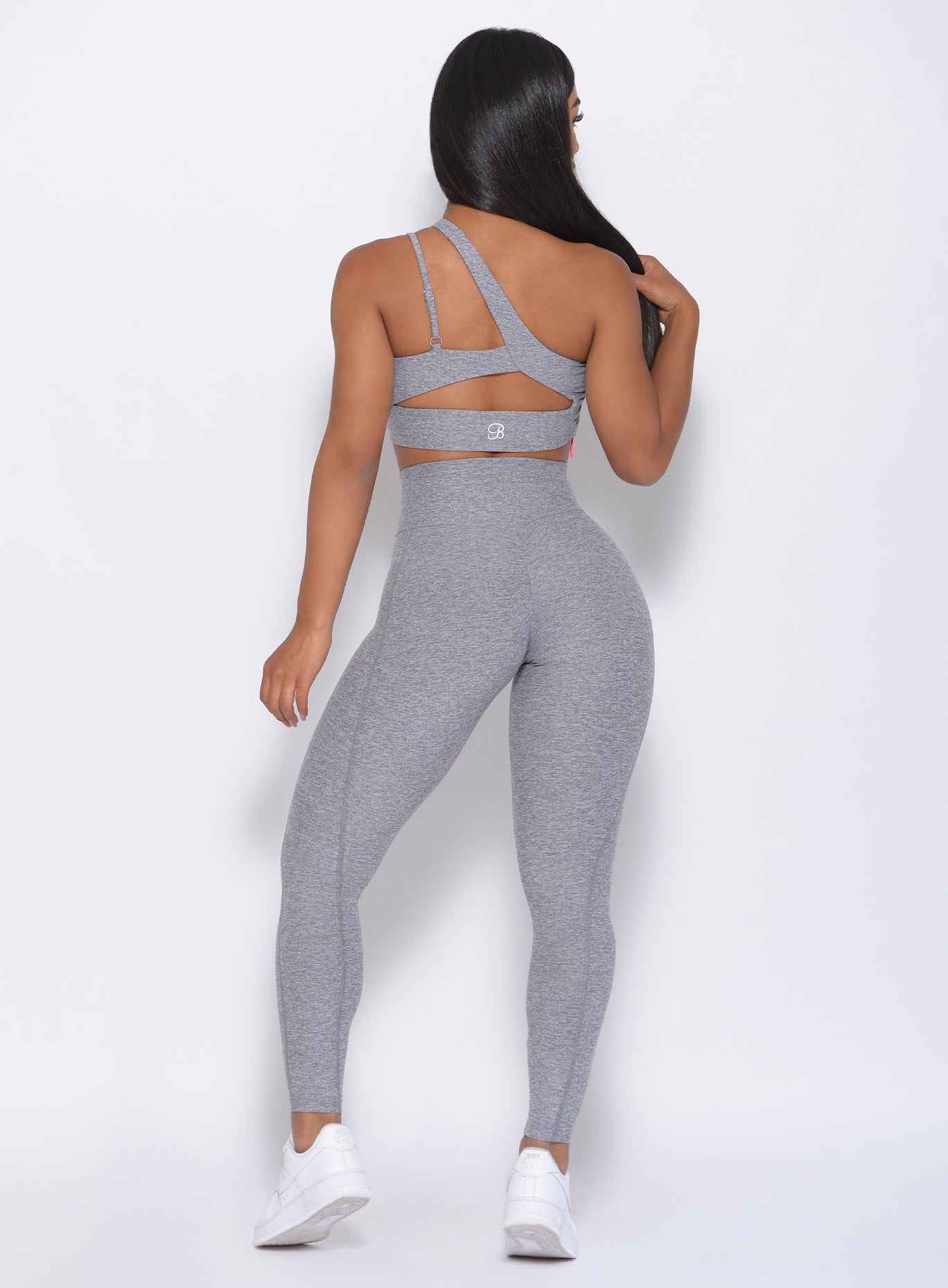 Back view of the model in our Brazilian Contour Legging in cloud color and a matching bra
