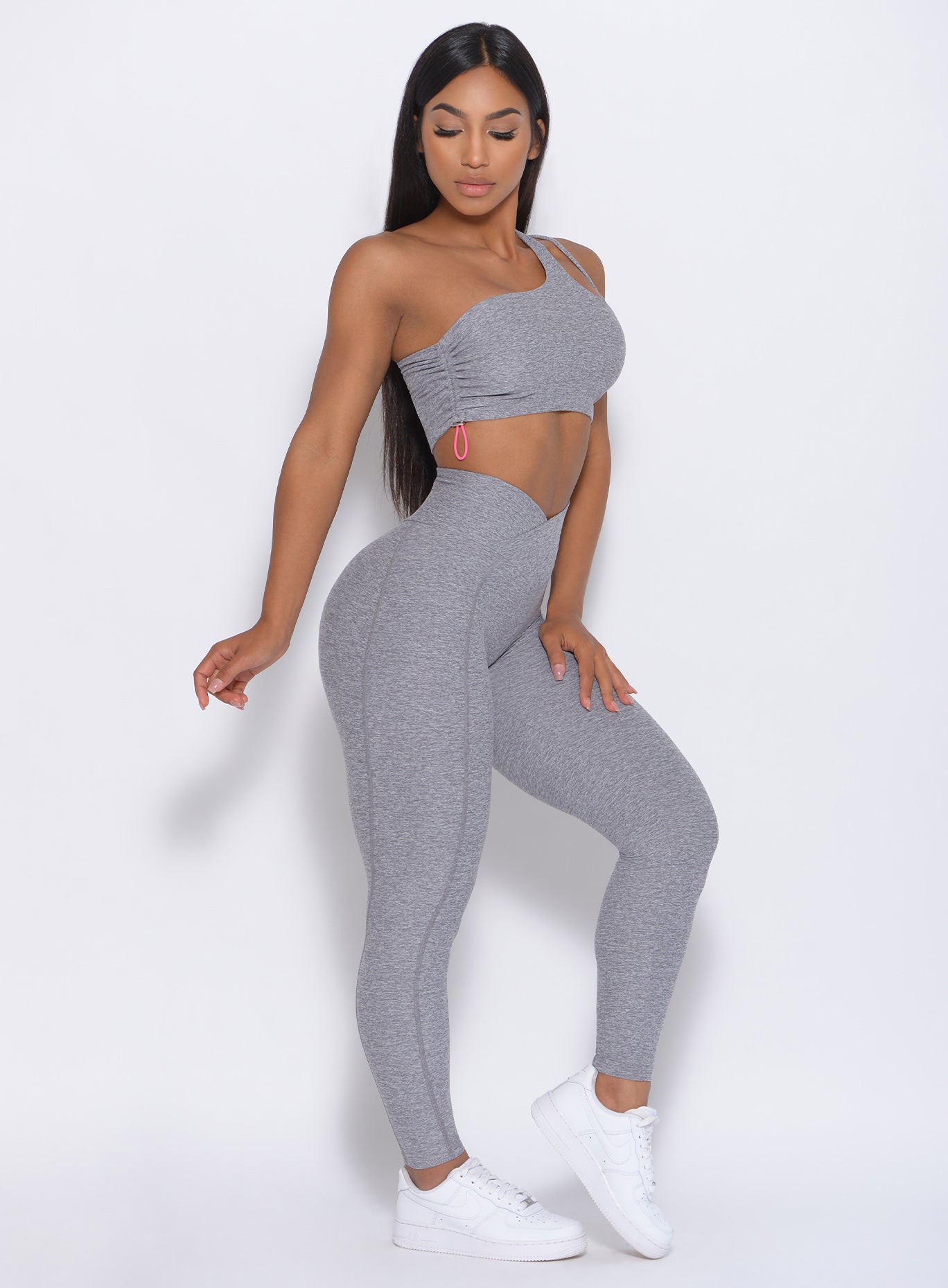 Right side view of the model with her left hand on thigh wearing our Brazilian Contour Legging in cloud color and a matching bra
