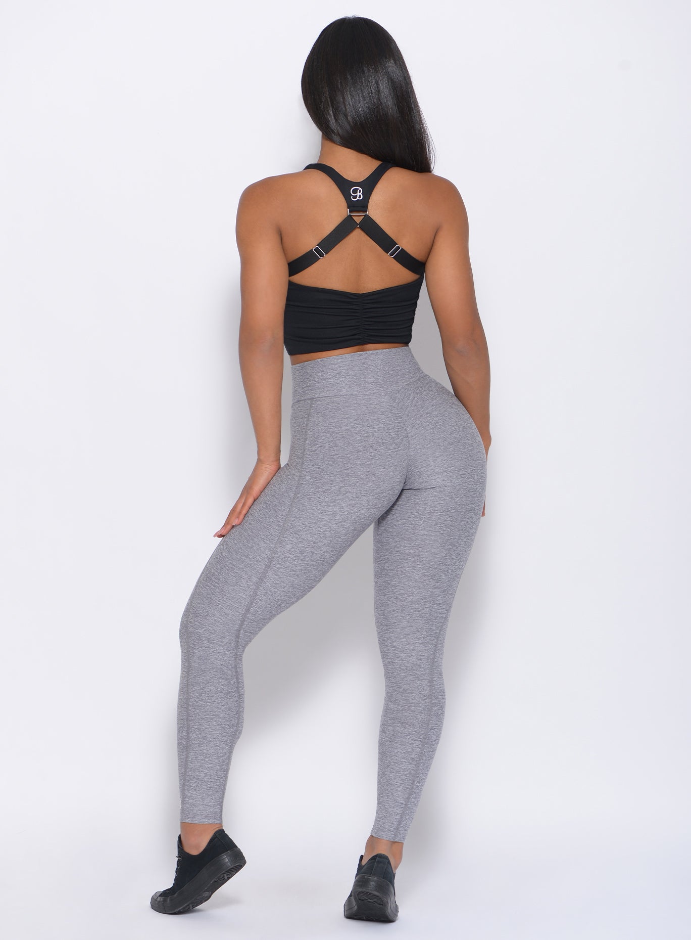 back view of the model in our Brazilian Contour Legging in cloud color and a black bra