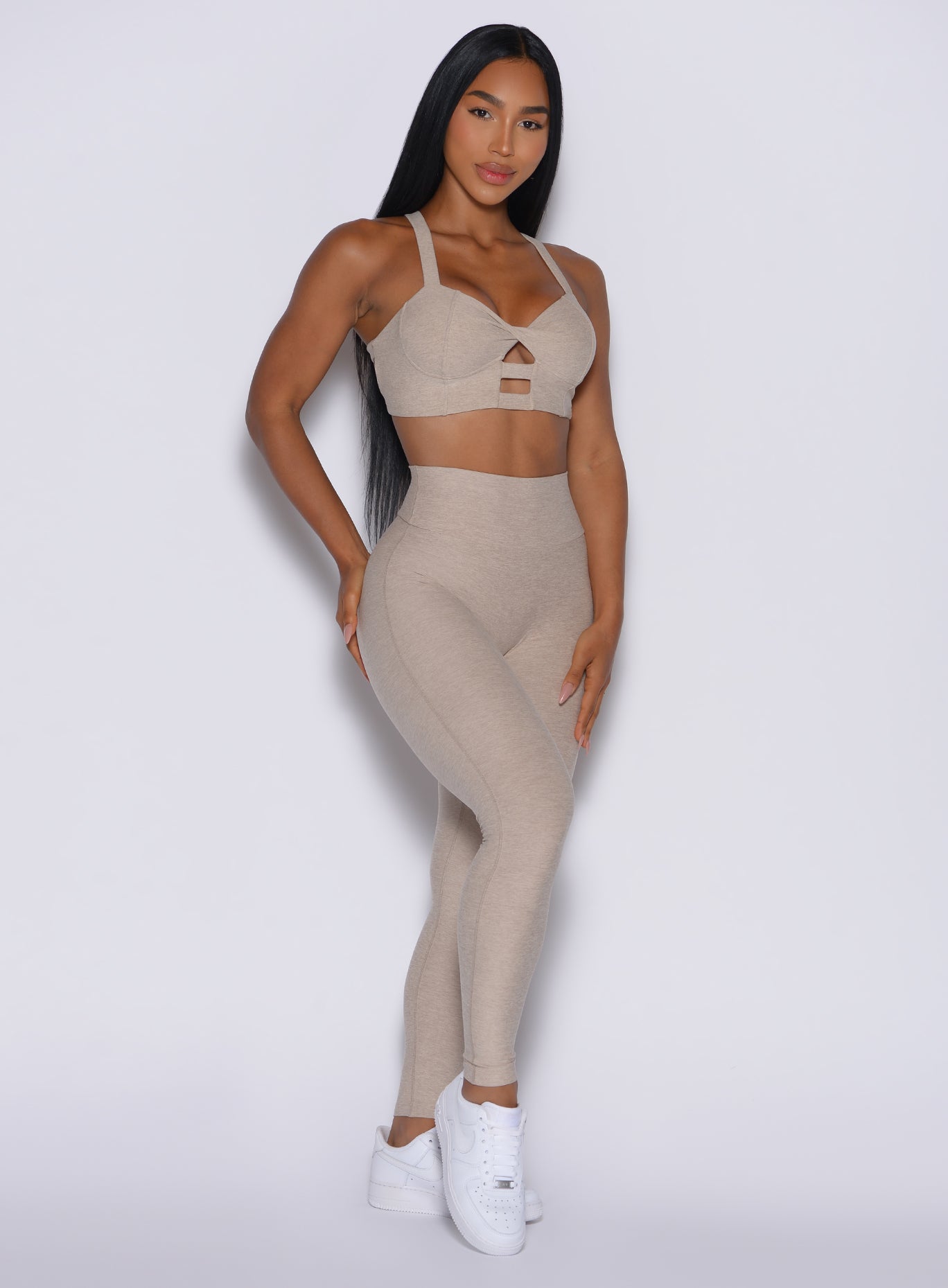front profile picture of a model in our Movement Leggings in Taupe color and a matching Sports Bra