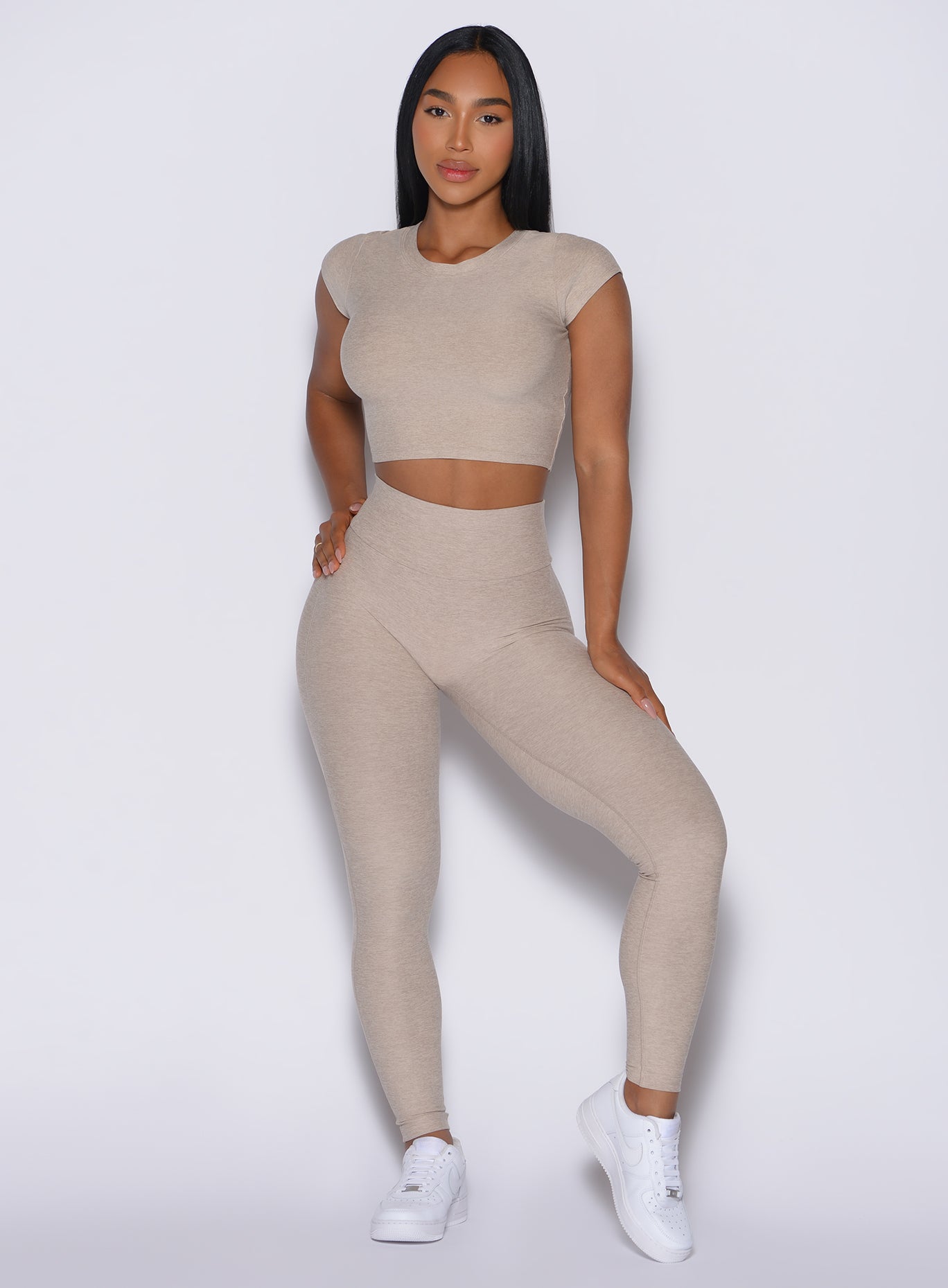 front profile view of a model wearing our Movement Leggings in Taupe color and a matching Tee