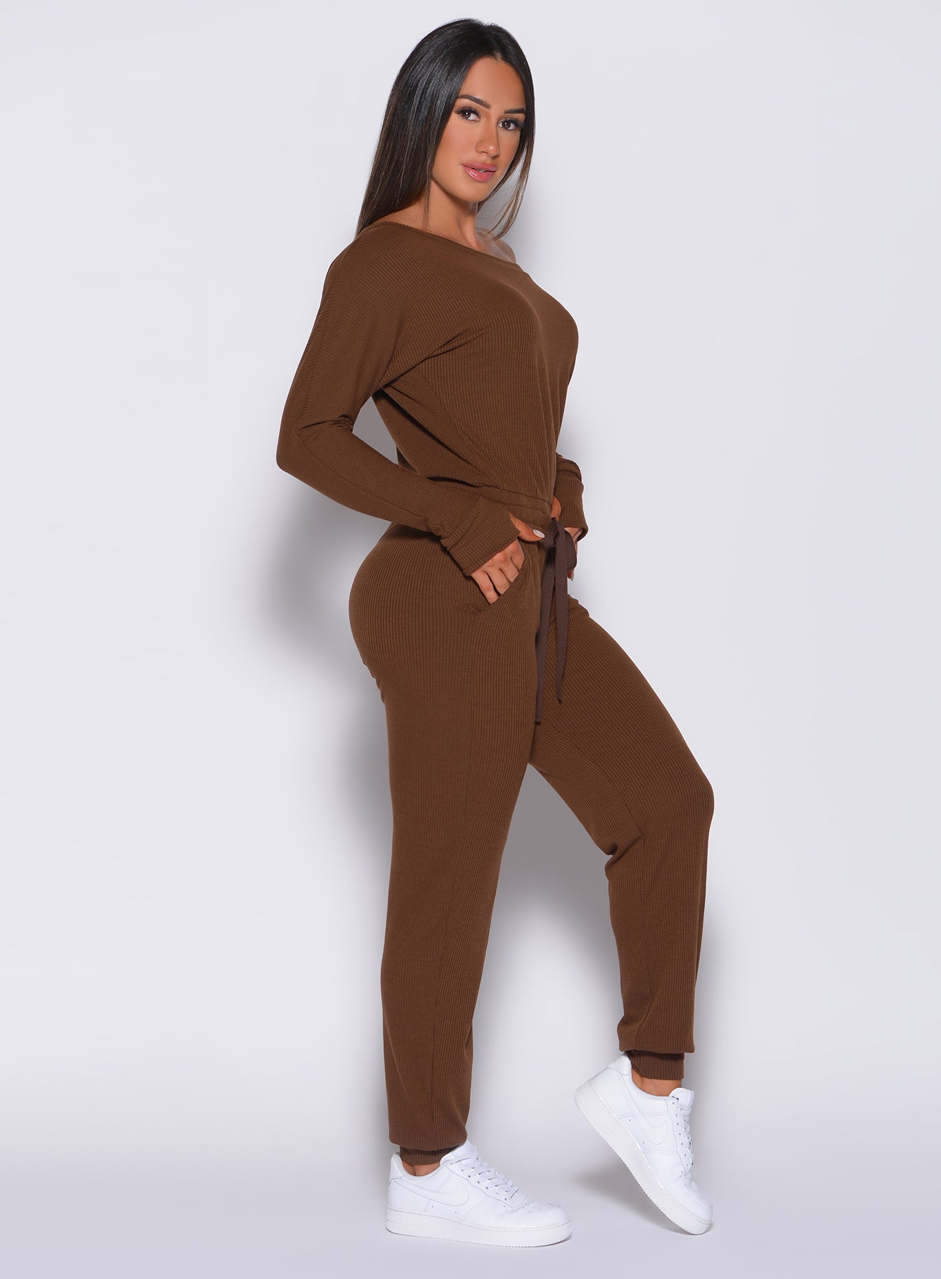 Right side profile view of a model wearing our rib jumpsuit in expresso color