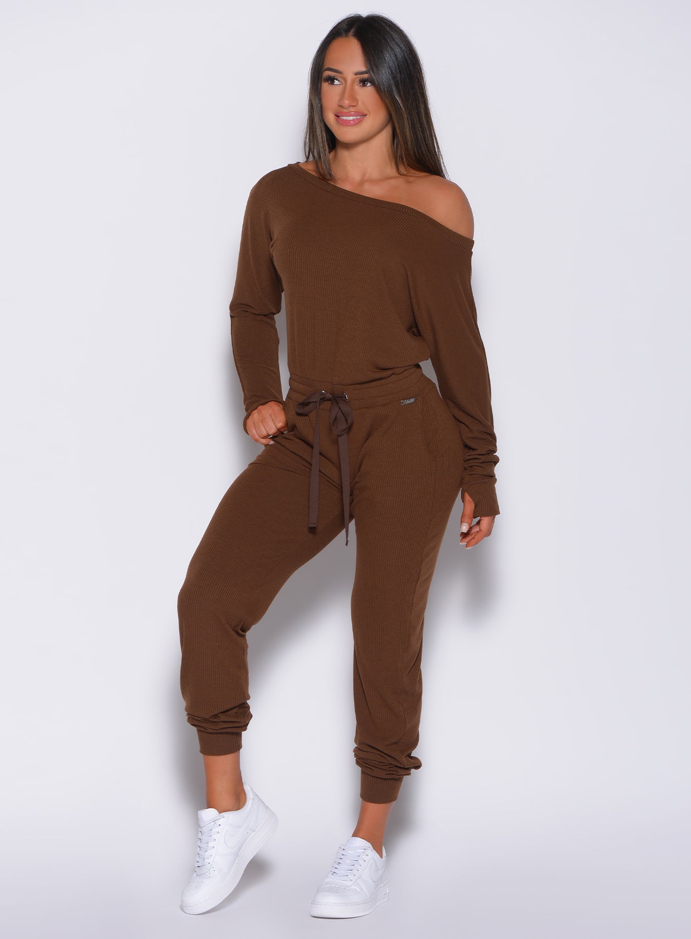 front profile view of a model in our rib jumpsuit in expresso color