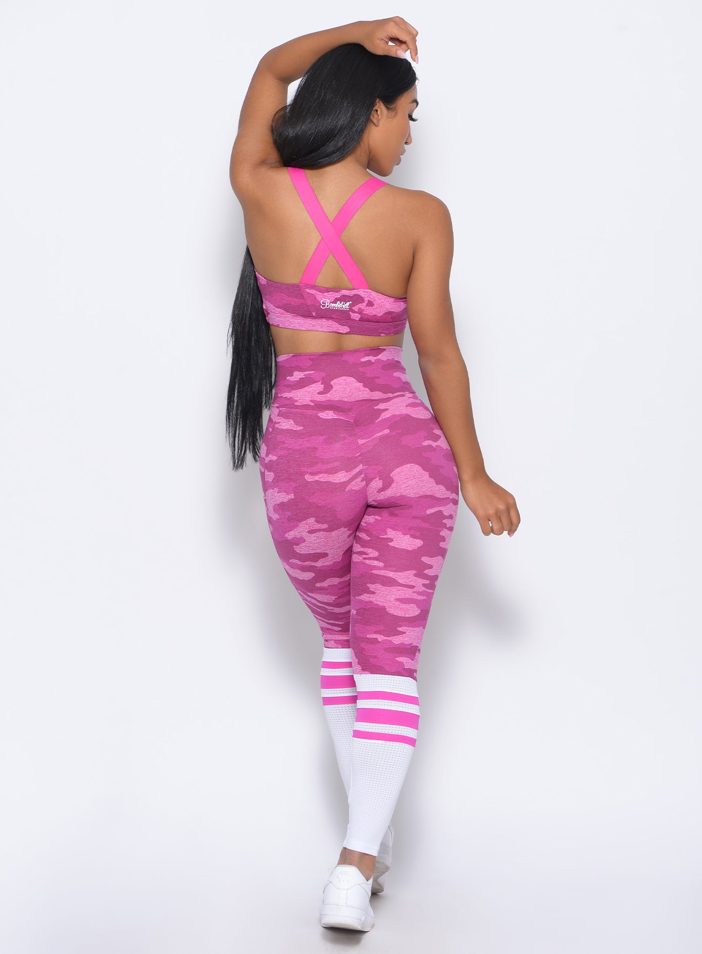 Back view of the model in our contour sock leggings in pink camo and a matching bra