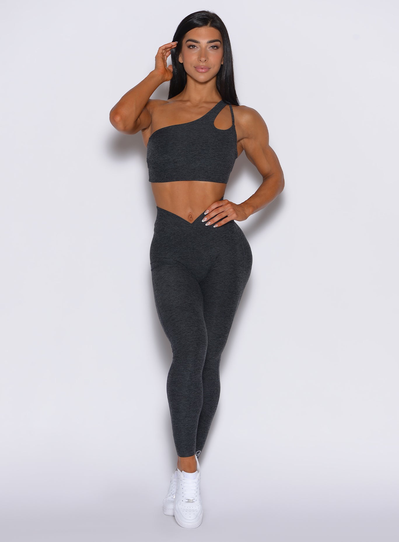 front profile view of a model wearing our V Active Leggings in charcoal color along with the matching top