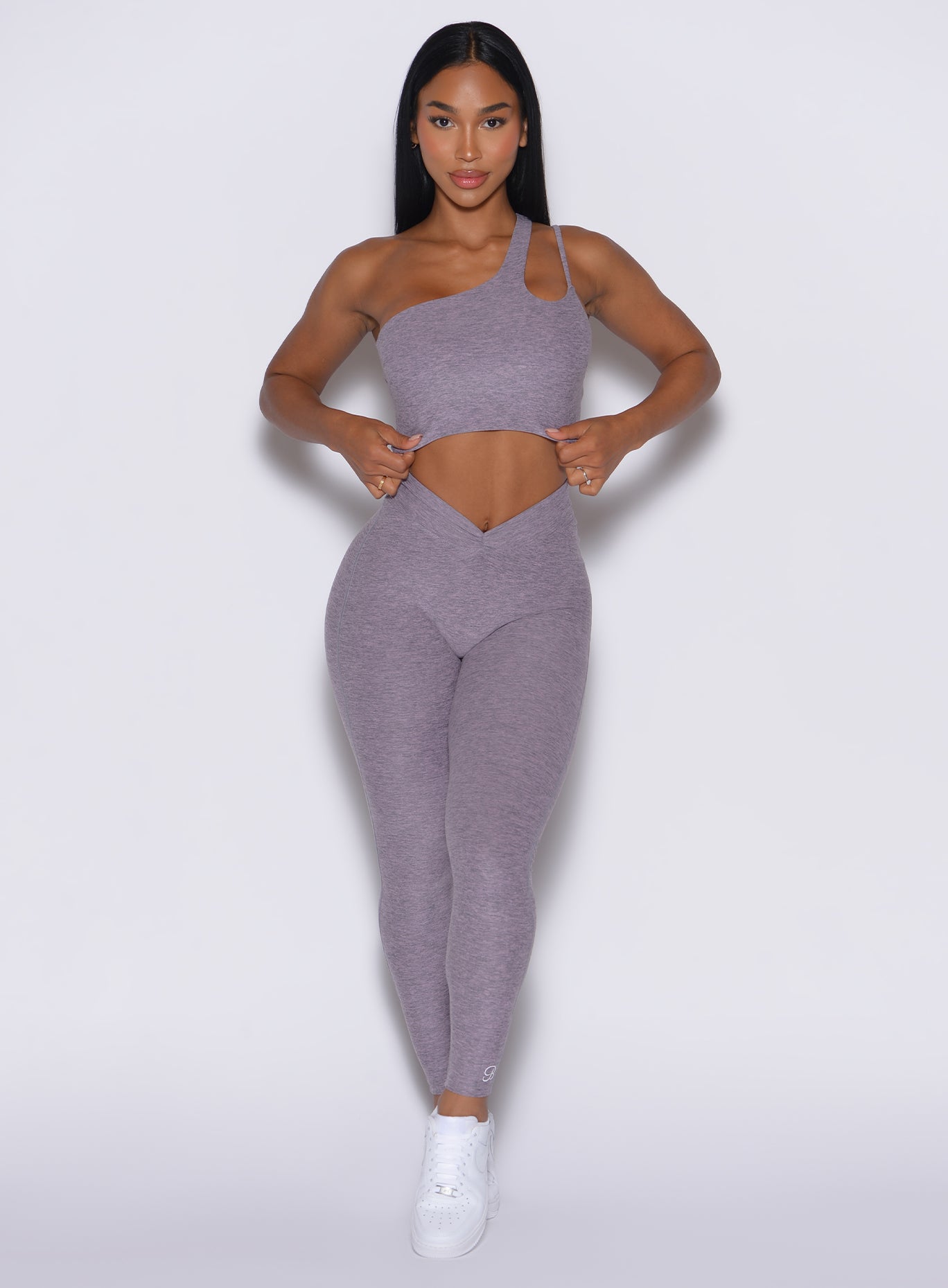 model facing forward wearing our V active leggings along with the matching lateral top